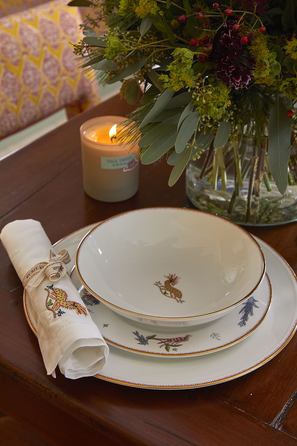Kit Kemp interiors | a bone china bowl, plate and napkin on a wooden table