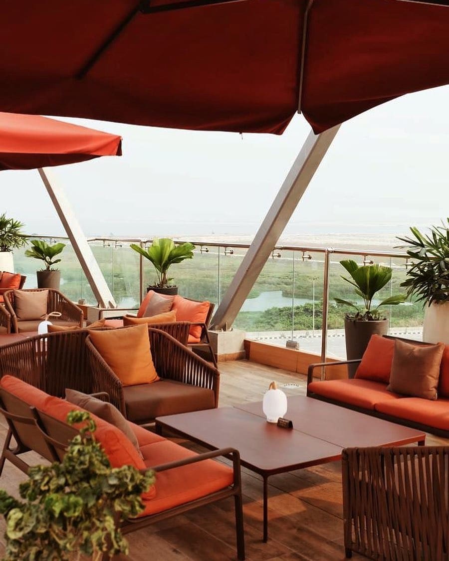 Nigerian author Damilare Kuku on how to make the most of Lagos | Túraká Restaurant on the roof of EbonyLife Place with orange cushioned chairs