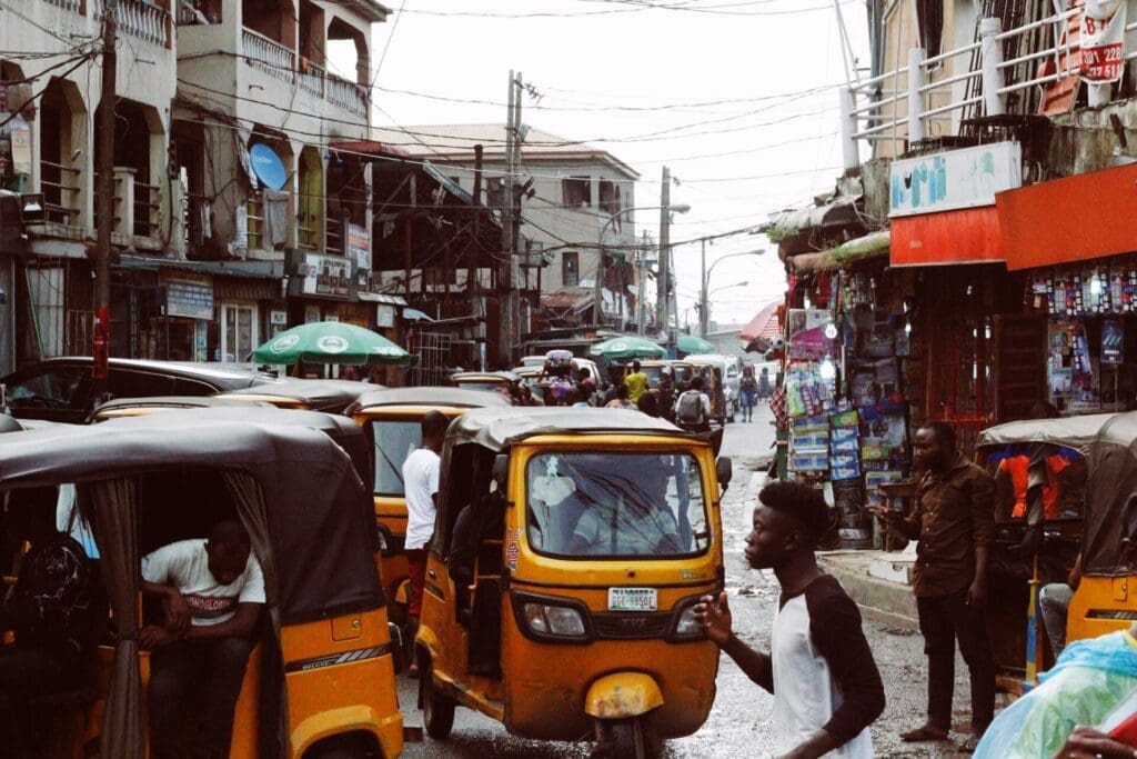 A A busy street in Lagos, with yellow taxis, people and buildings