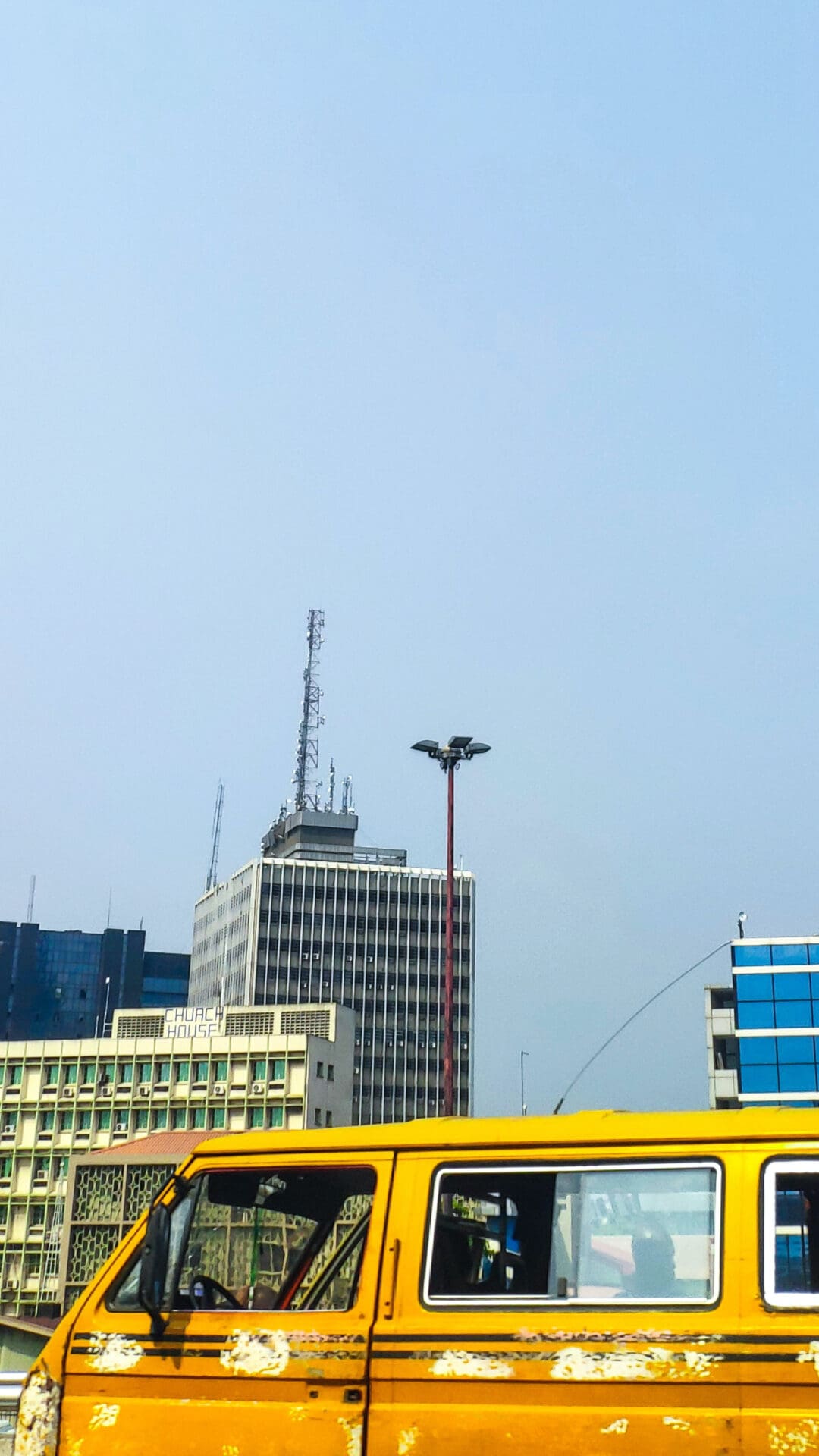 Lagos City Guide | A yellow van drives down a highway in Lagos, Nigeria