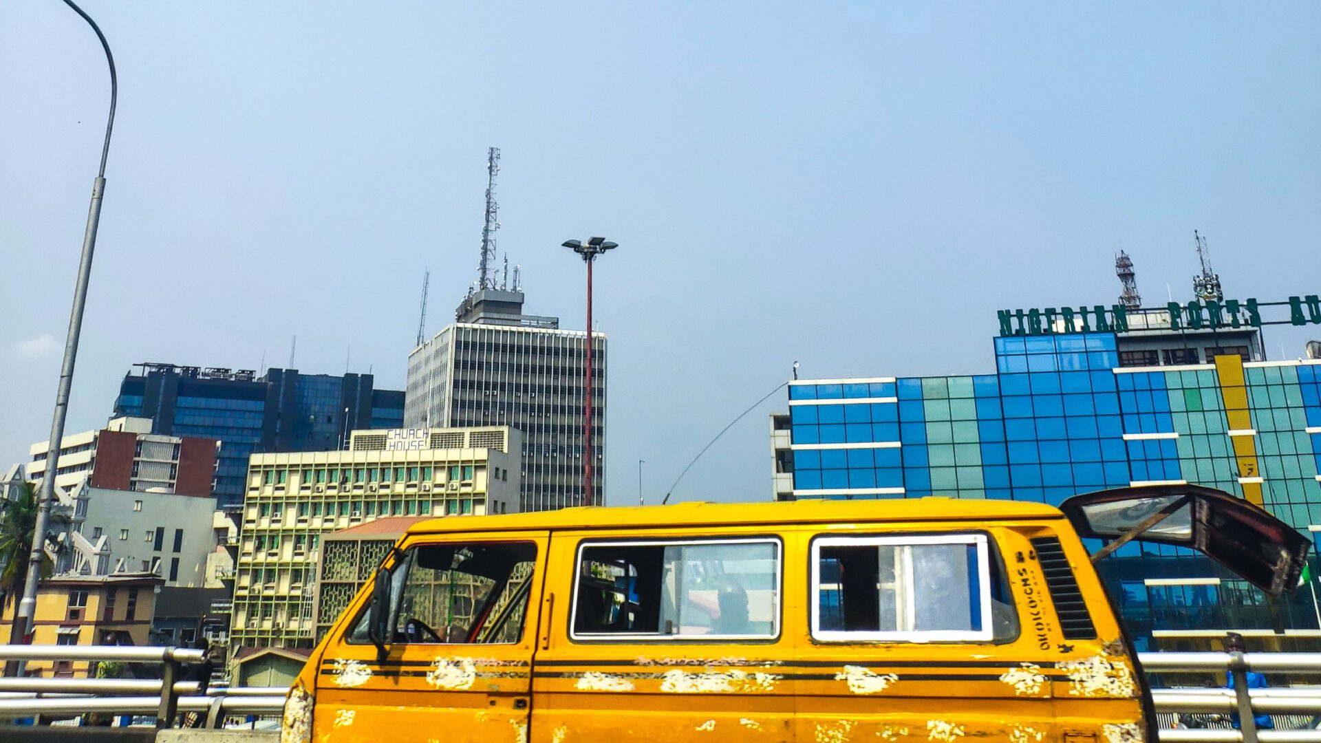 Lagos City Guide | Yellow van moving down a highway in Lagos, Nigeria