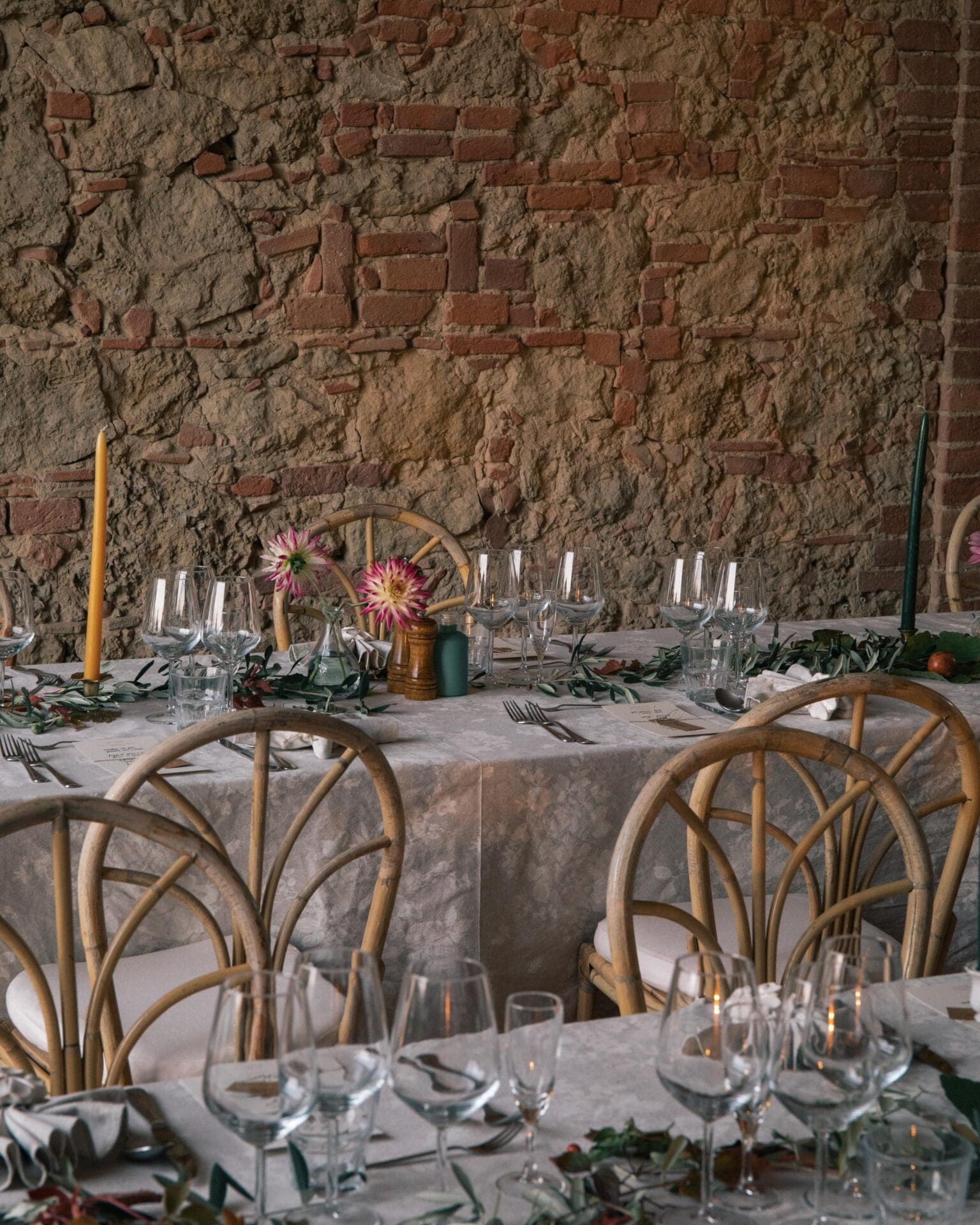 Inside Villa Lena: an art retreat and hotel in the Tuscan hills | Table set in front of brick wall for a event at Villa Lena