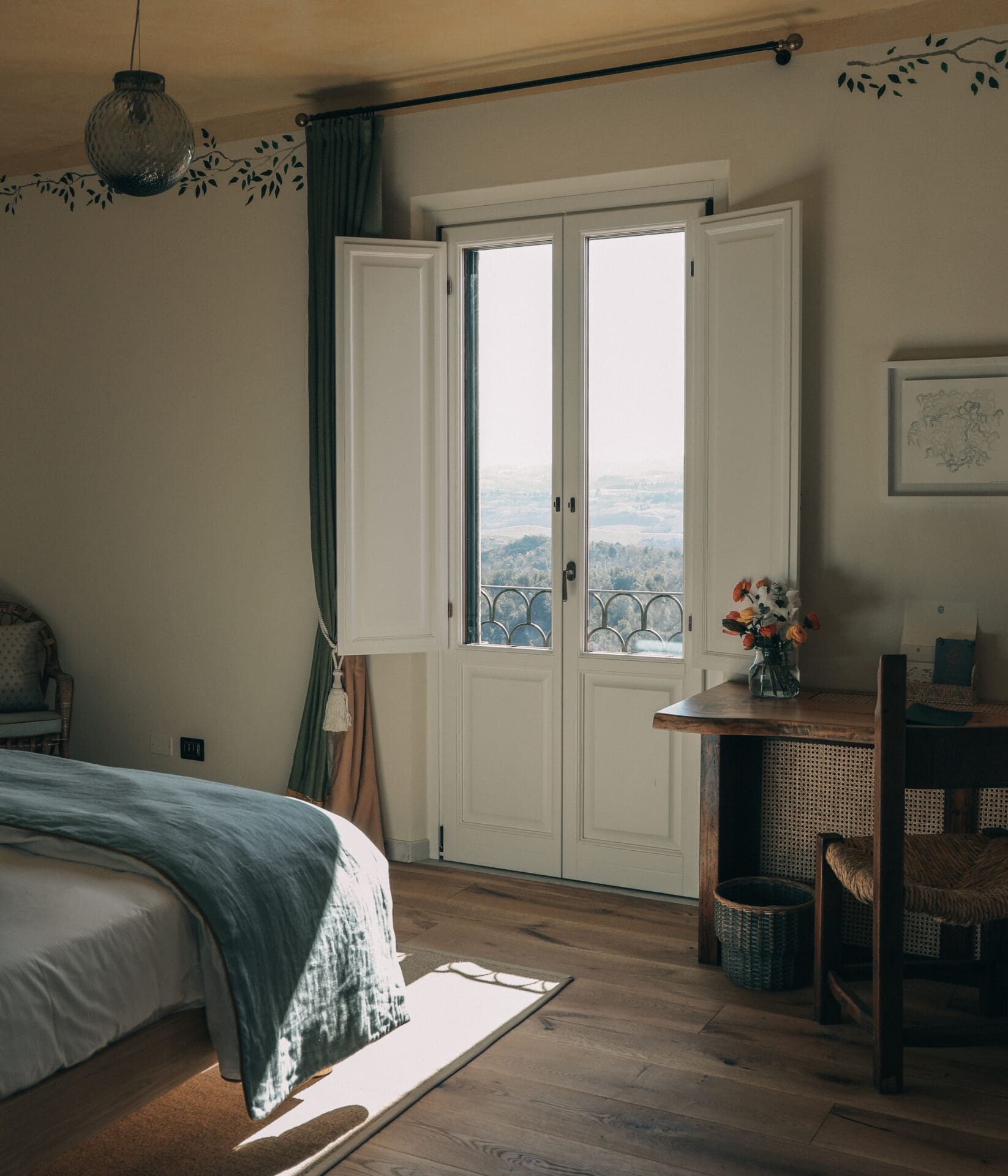 A bedroom in the San Michele building with a window overlooking the hills