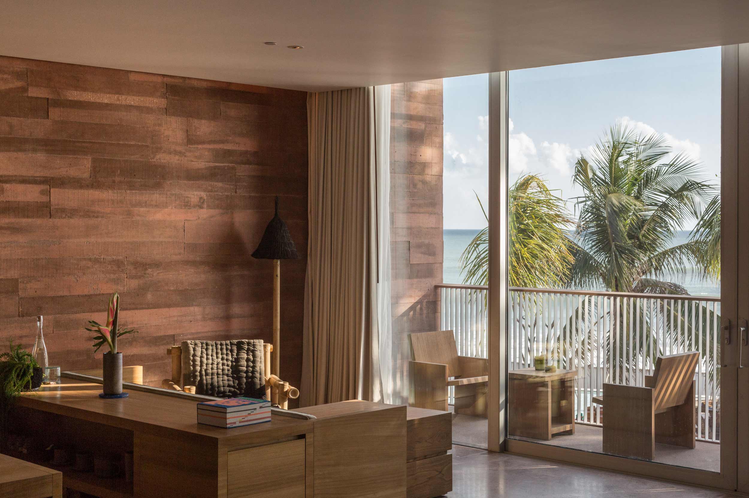 The rise of transformational retreats | a bedroom at Potato Head, Seminyak Bali, with palm tree views