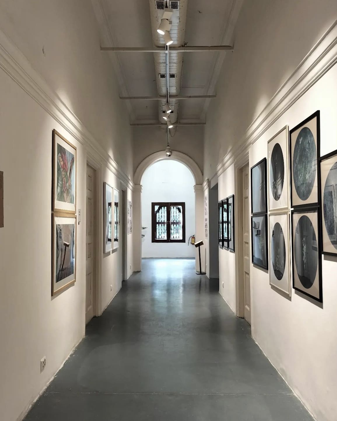 The best things to do in Alibaug | art hangs the corridor walls in a gallery space