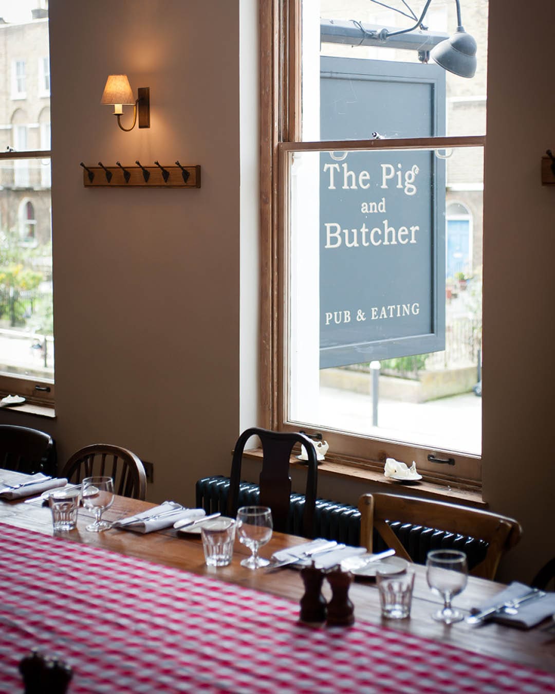 The best private dining rooms in London | The private dining room at The Pig & Butcher in Islington made snug with gingham table runners and warm lighting