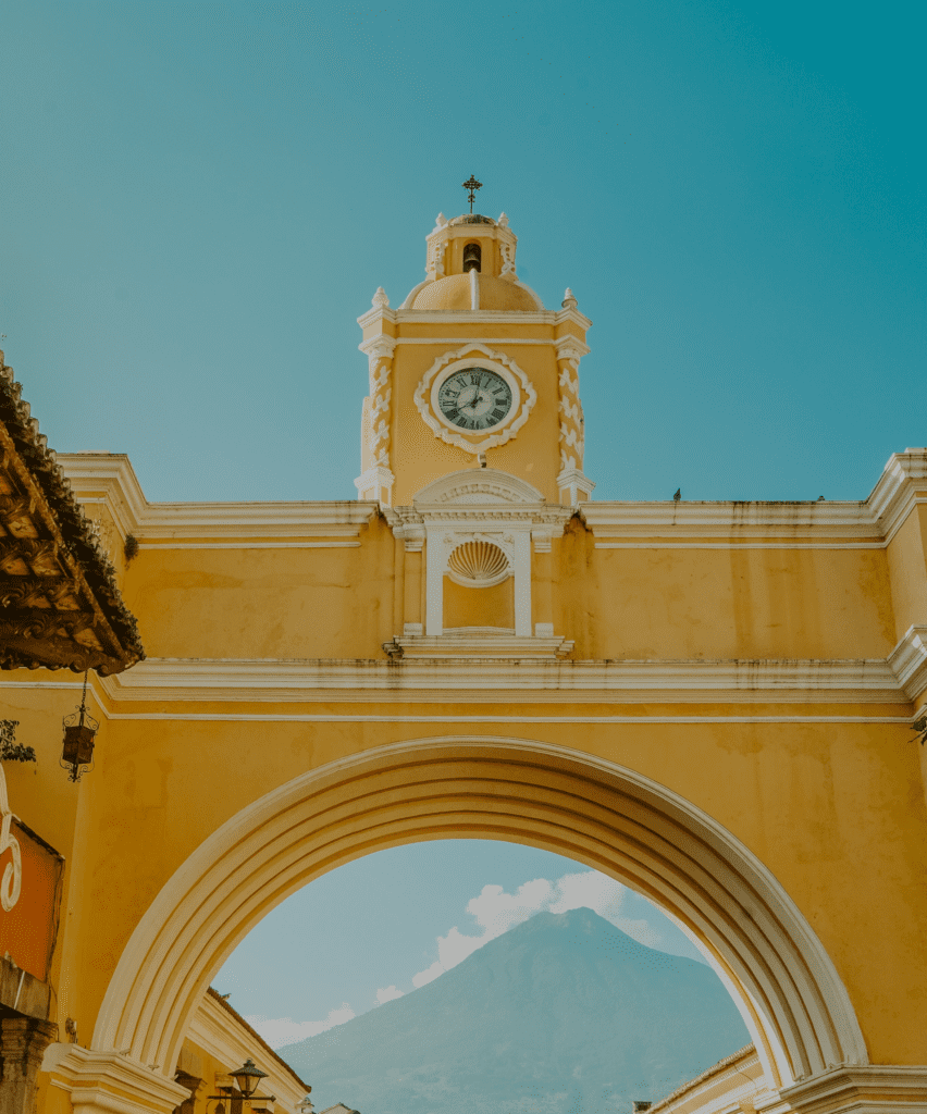 Travel trends 2023 | a gold-tone building beneath a blue sky in Antigua Guatemala