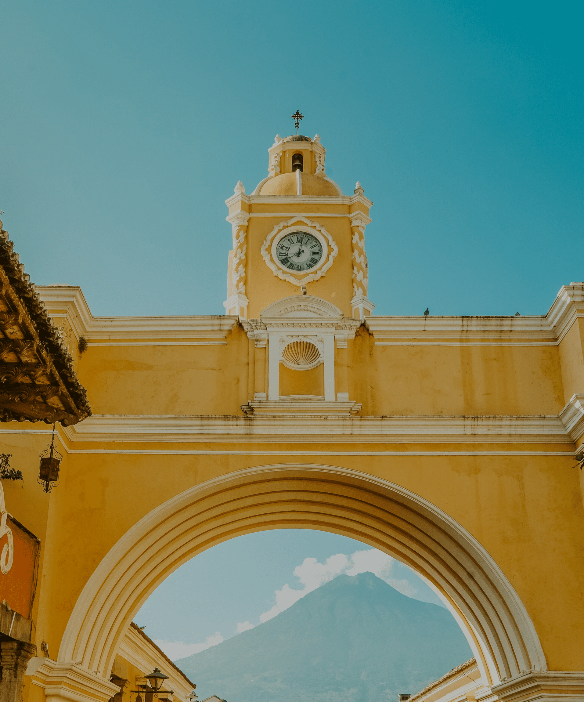 a gold-tone building beneath a blue sky in Antigua Guatemala