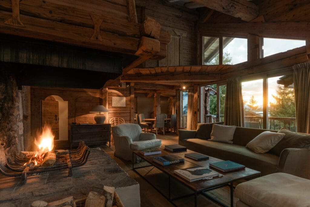 The most spectacular places to stay in the Alps this winter | A cosy sitting room with an open fire at Zannier Hotels Le Chalet