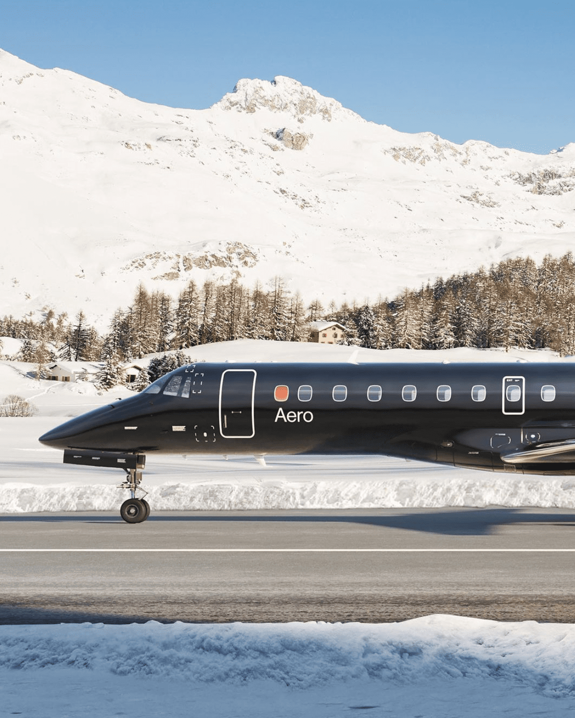 Aero semi-private jet service | a plane against a snowy mountain backdrop
