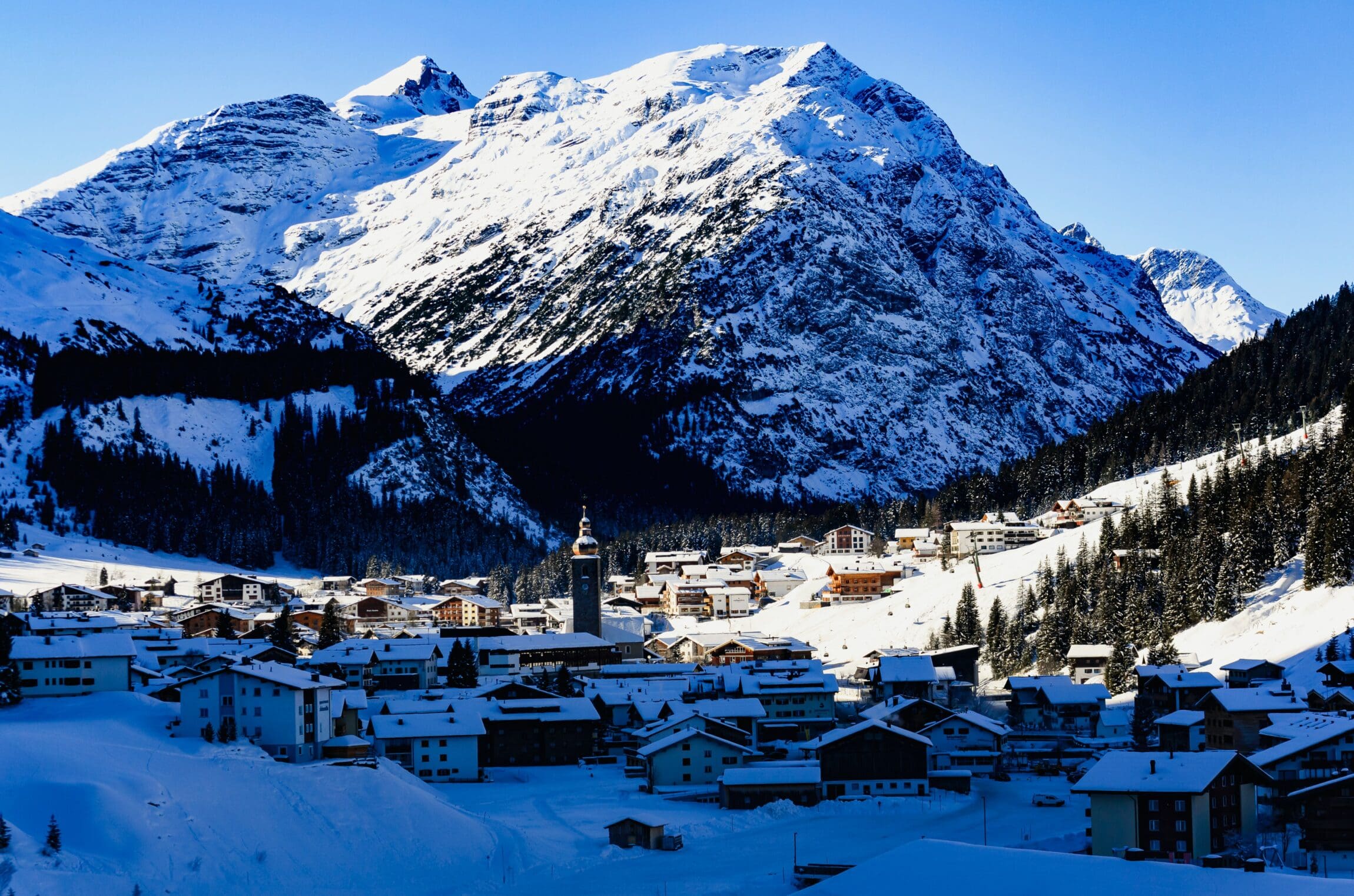 A view of the village of Lech in a small snowy valley