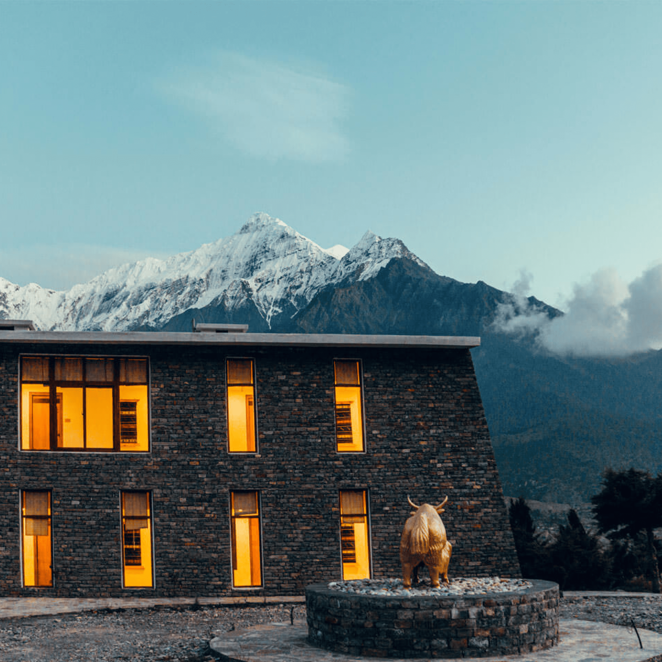 Exterior of Shinta Mani in Nepal with large snow covered mountain in the background