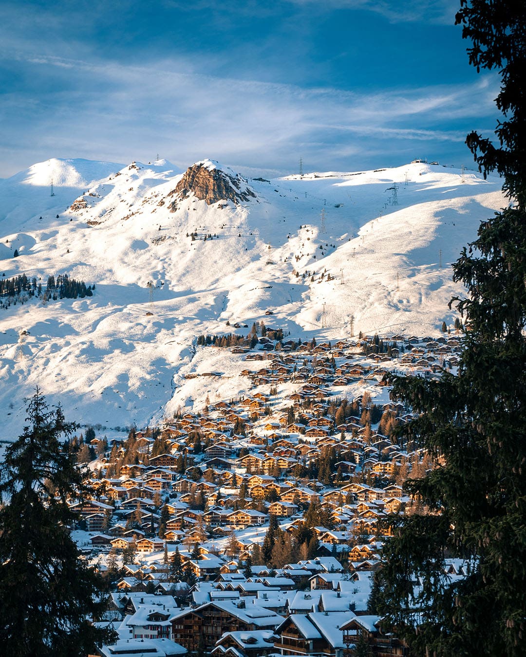 A view of Verbier in the sunlightwith snow capped mountains