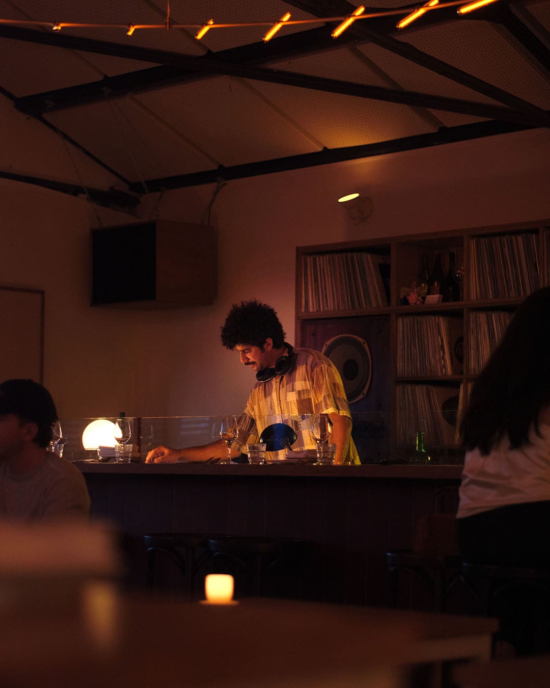 A DJ spinning vinyl at Cornerstore restaurant in Amsterdam