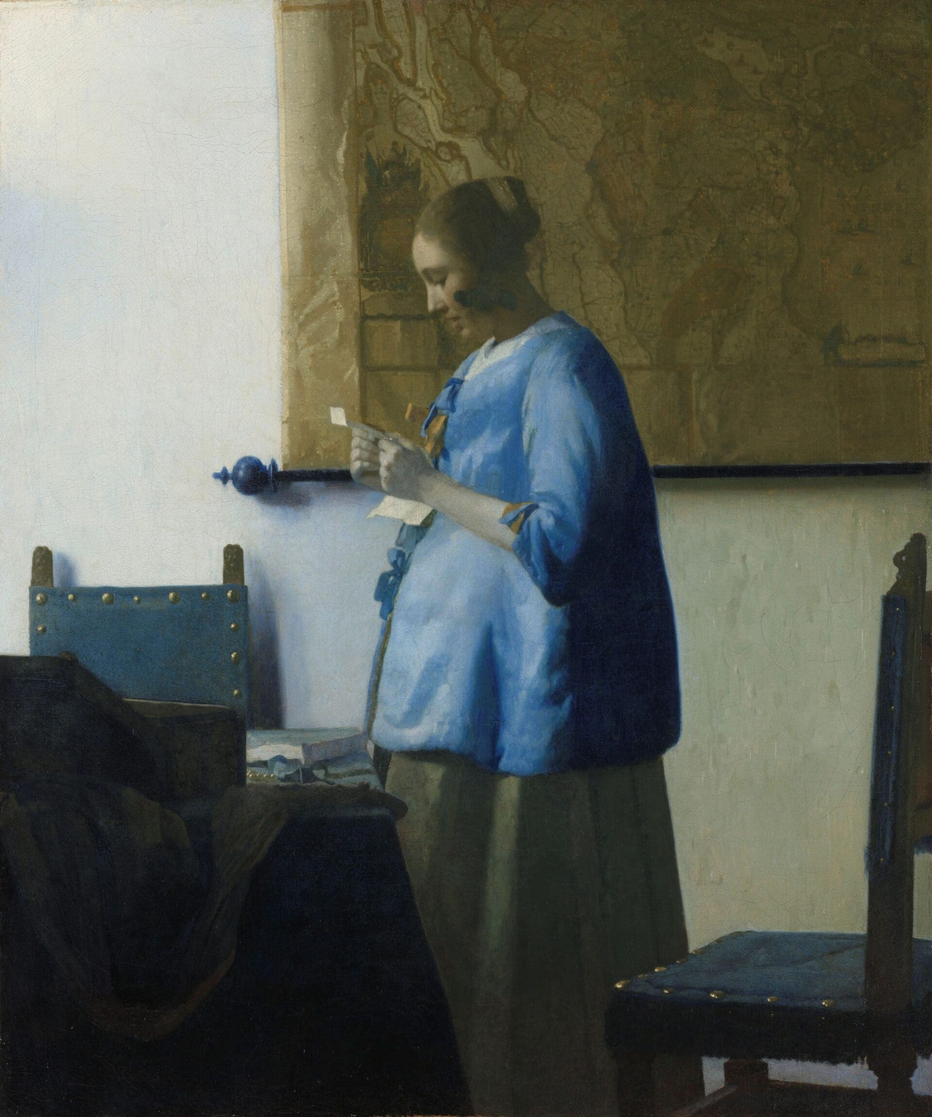 The best museums and art galleries in Amsterdam | Painting of a woman in blue shirt reading a letter.