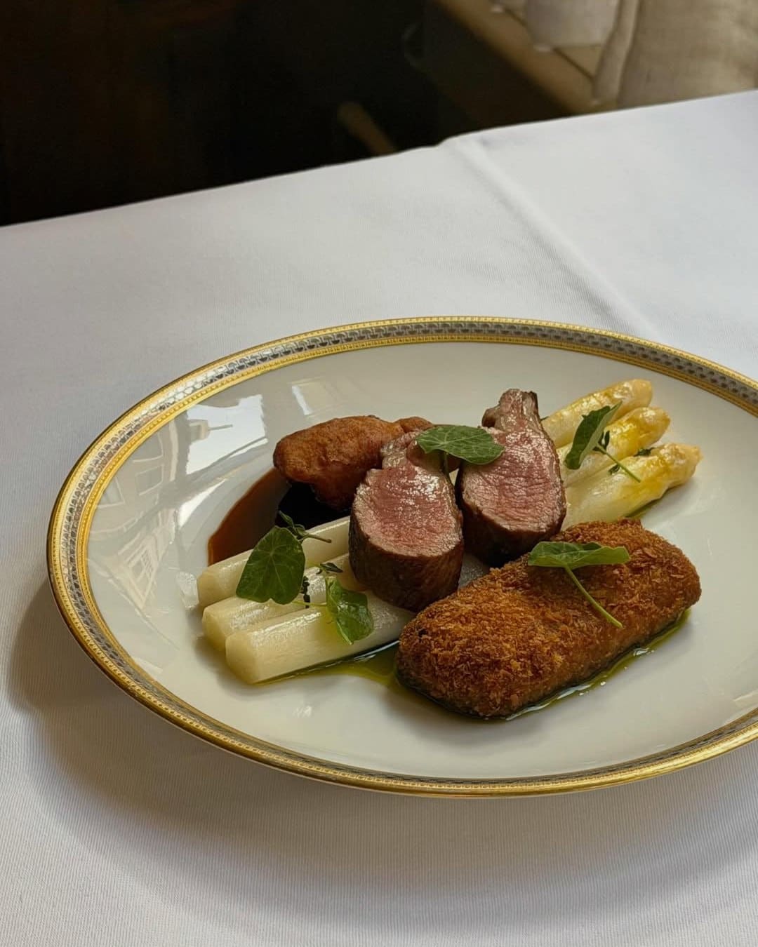 roasted saddle of lamb, lamb croquette and lamb sweetbreads atop white asparagus at Christiaan Smit