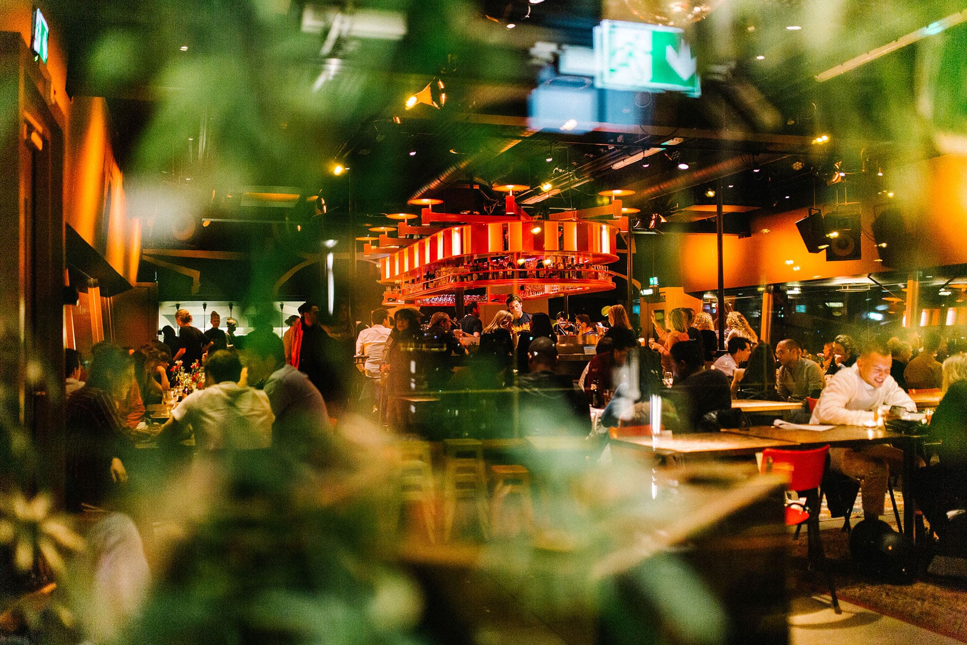 People enjoying themselves at the lively social space of the Canvas Restaurant in Volkshotel