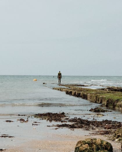 Kent Coastline | The Kent coastline with somebody standing at the edge of the water