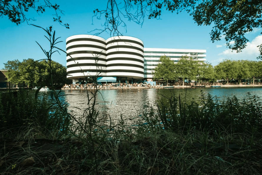 The best bars in Amsterdam | revellers at Waterkant, a canal-side bar