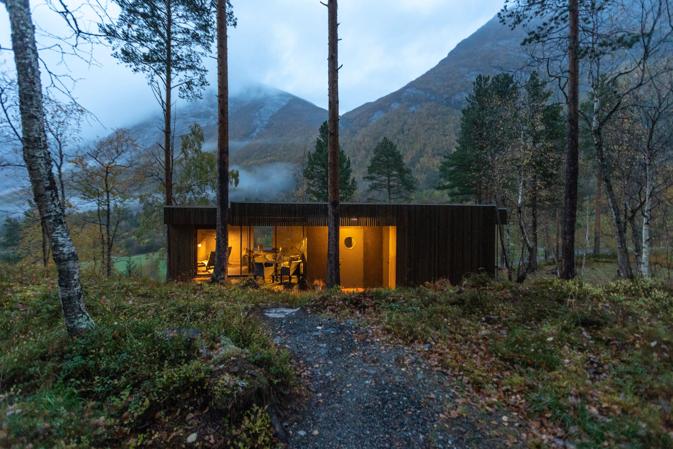 Hotel Wellness | A log-house in woodland surrounds with floor-to-ceiling windows at Hotel Juvet, Norway