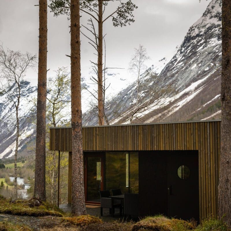 What does the future of hotel wellness look like? | Writers lodge in a field of green moss with a snowy mountain in the background
