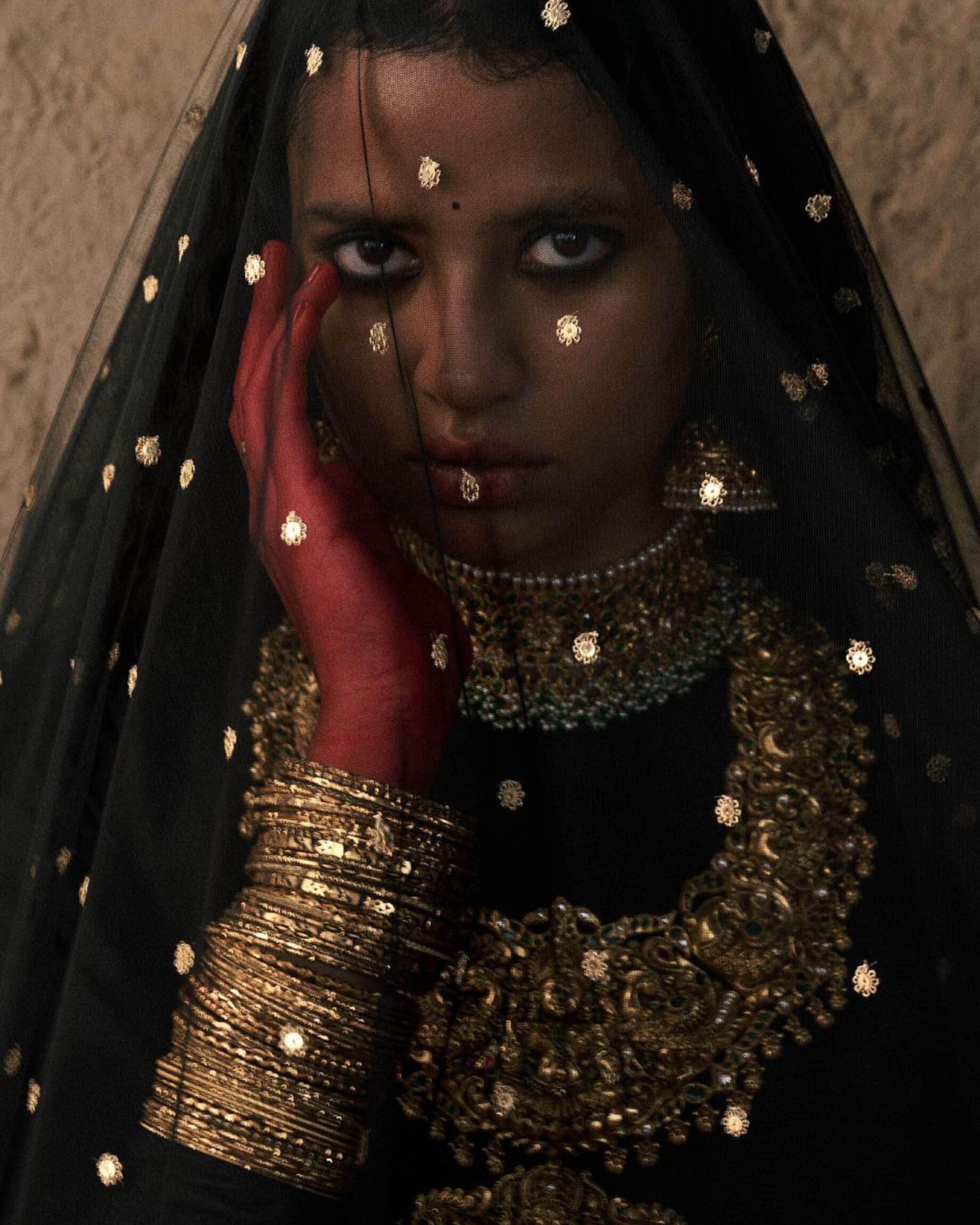 Mumbai creatives | A woman wearing dark eyeliner wearing a traditional veil over her face.