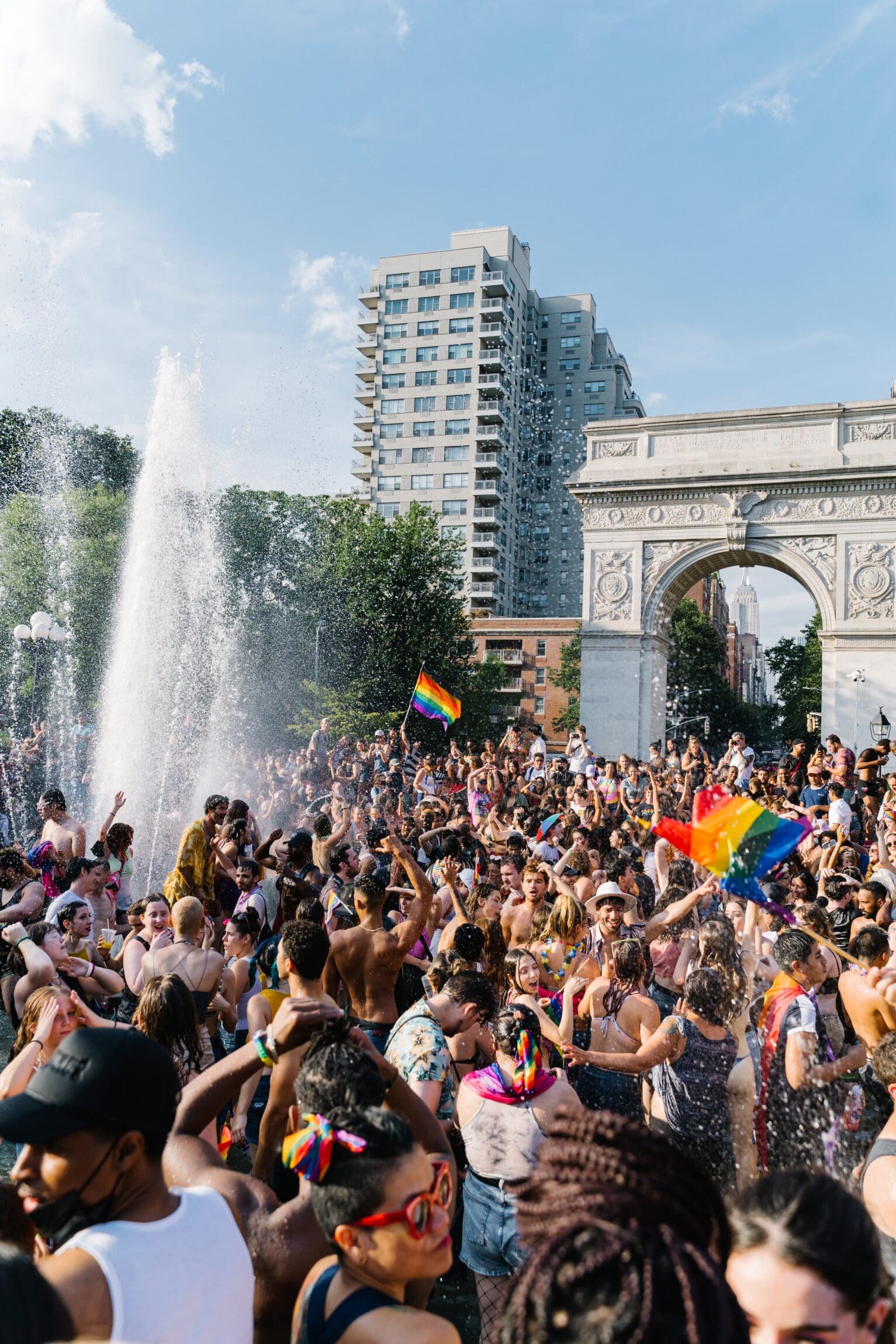 The future of queer travel | pride celebrations with crowds by a fountain