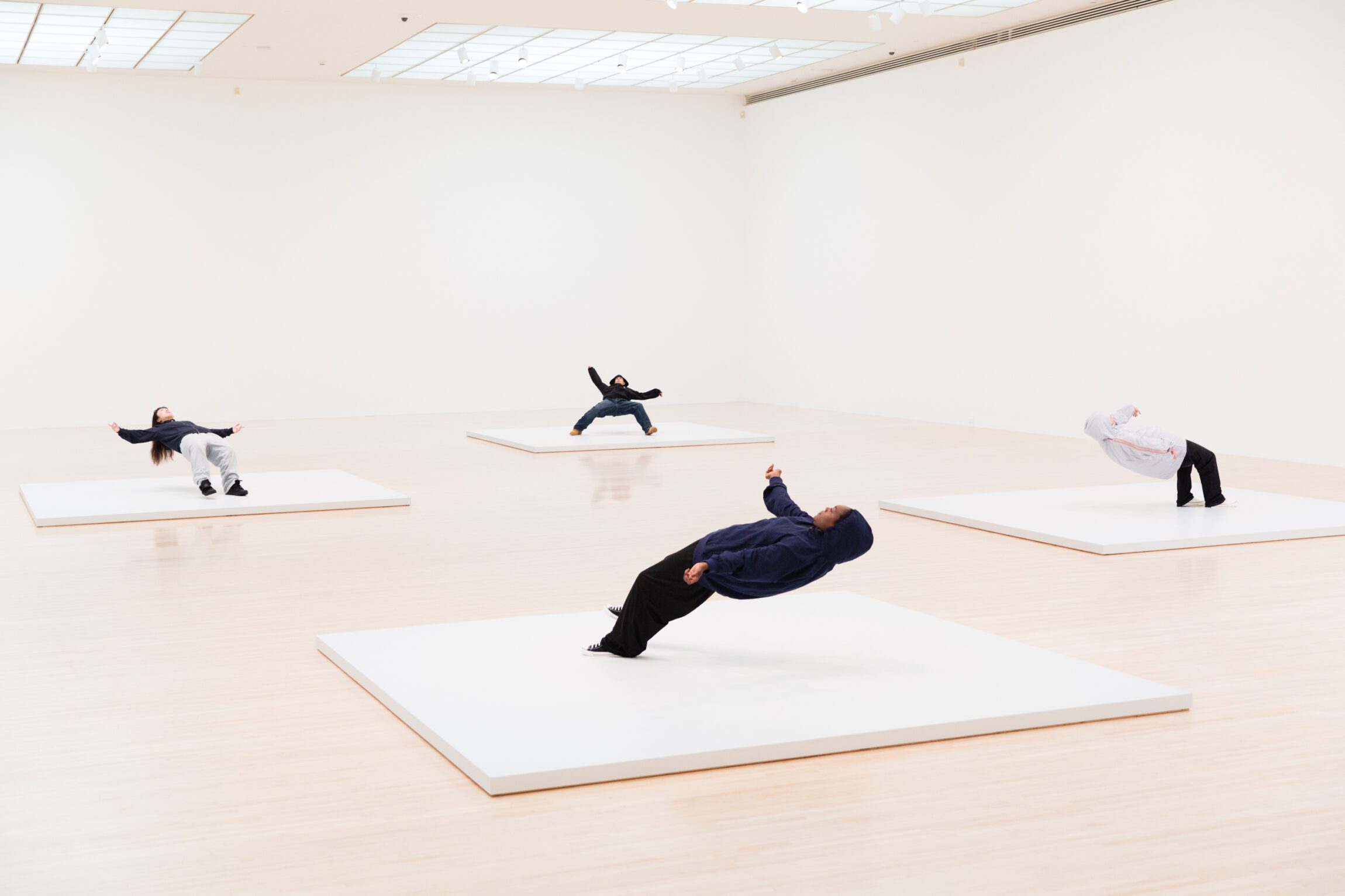 Things to do in Bangkok right now | Instillation of four people bent backwards on white tiles