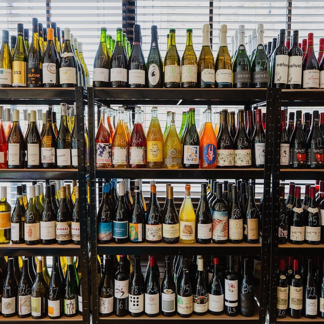 The best restaurants in Peckham | wine bottles on a shelf at Peckham Cellars