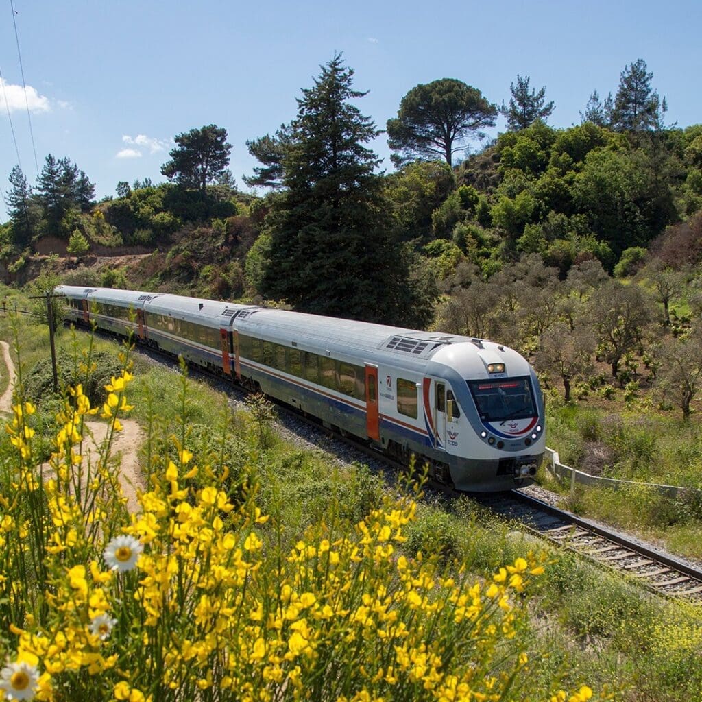 The best European trains | a train from Istanbul to Ankara, Türkiye with spring flowers in bloom