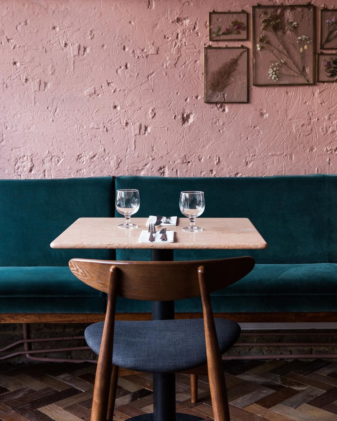 The best restaurants in Peckham | pink exposed brick walls and a velvet banquette interior at Kudu