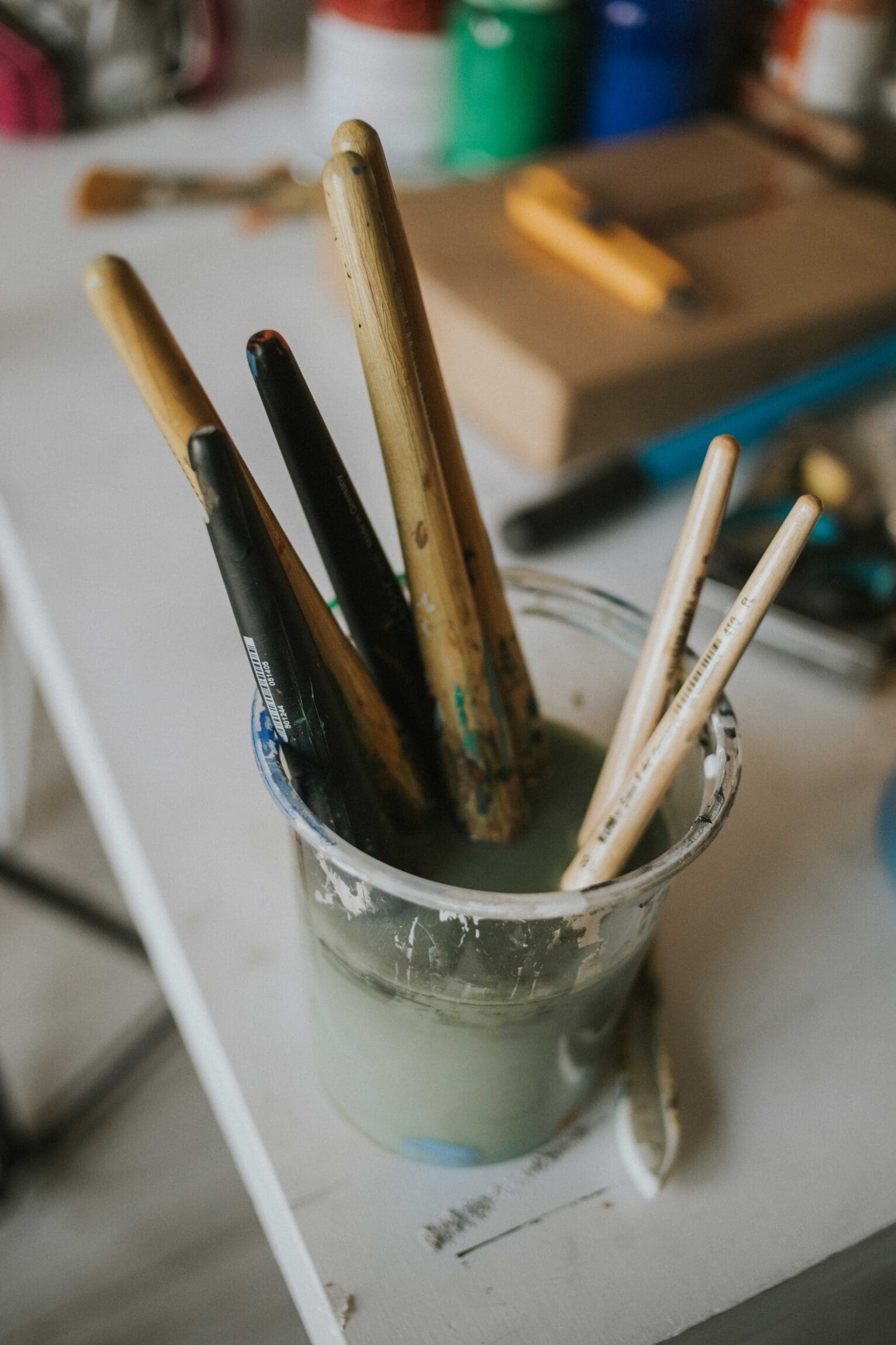 Used brushes in a cup of water at artist Luisa Salas's home studio