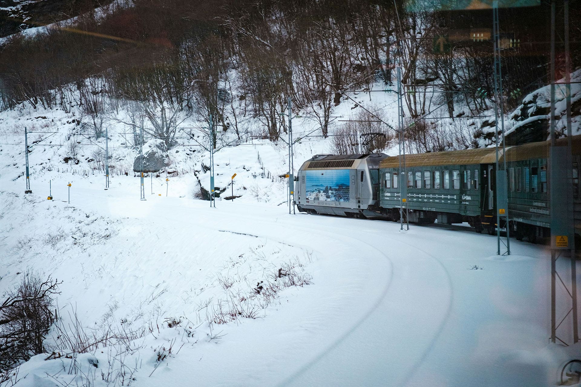 Train rounding a bend in the snow and ice