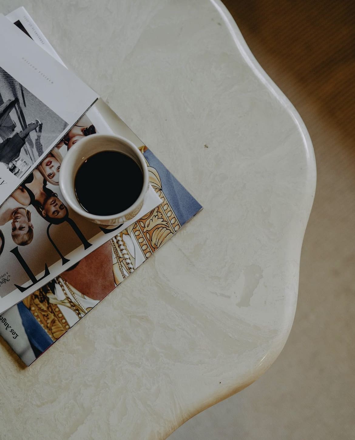 The best coffee shops in Los Angeles | Cup of coffee sitting on a pile of magazines