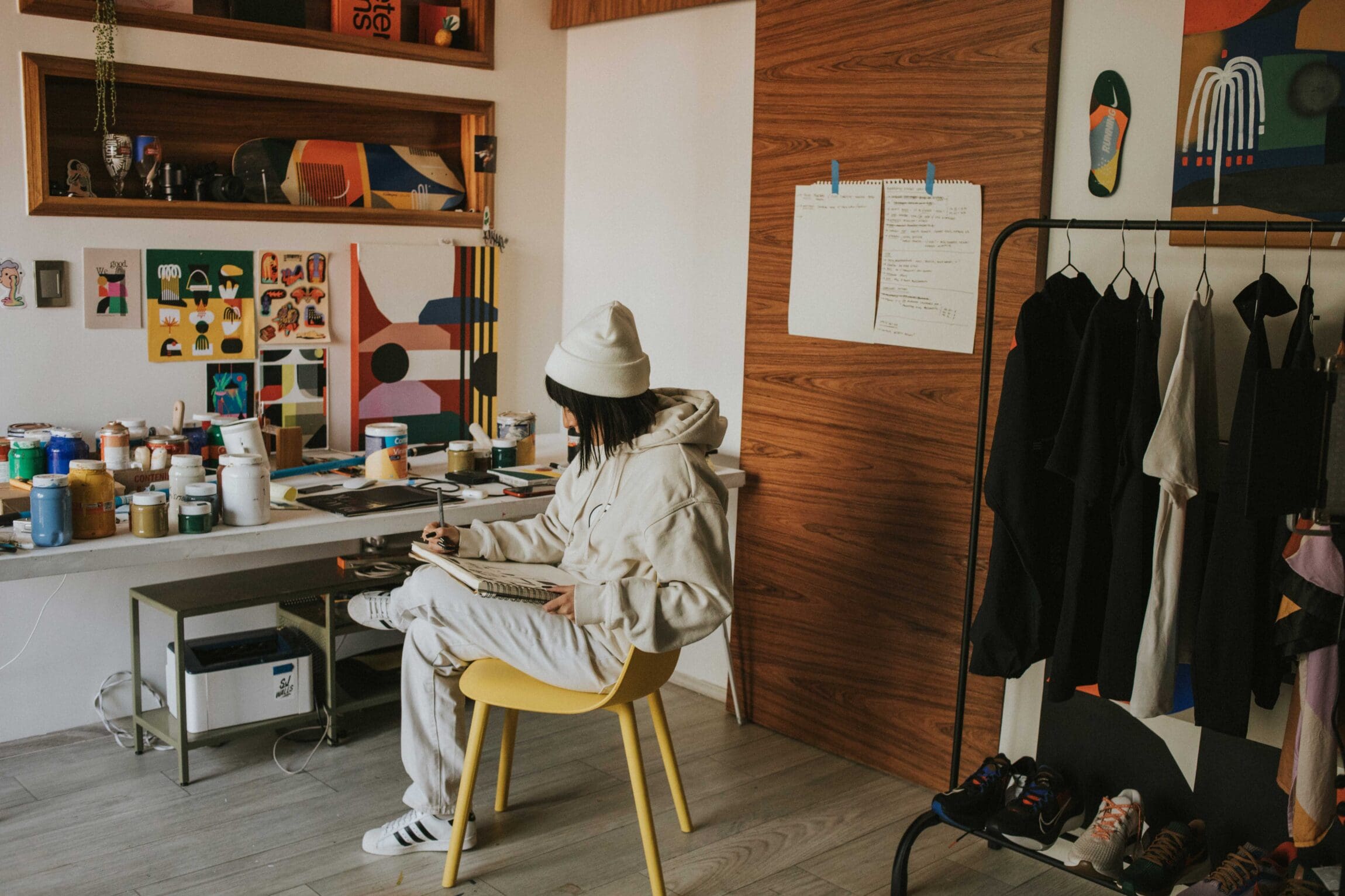 Artist Luisa Salas, aka Hola Lou, shot for ROADBOOK in her home studio, sat at her desk.