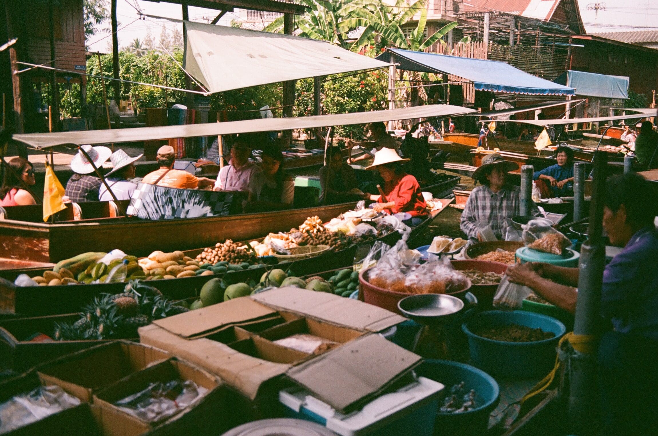 Tourist taxes | A busy floating market in Thailand. Photography by Rach Teo