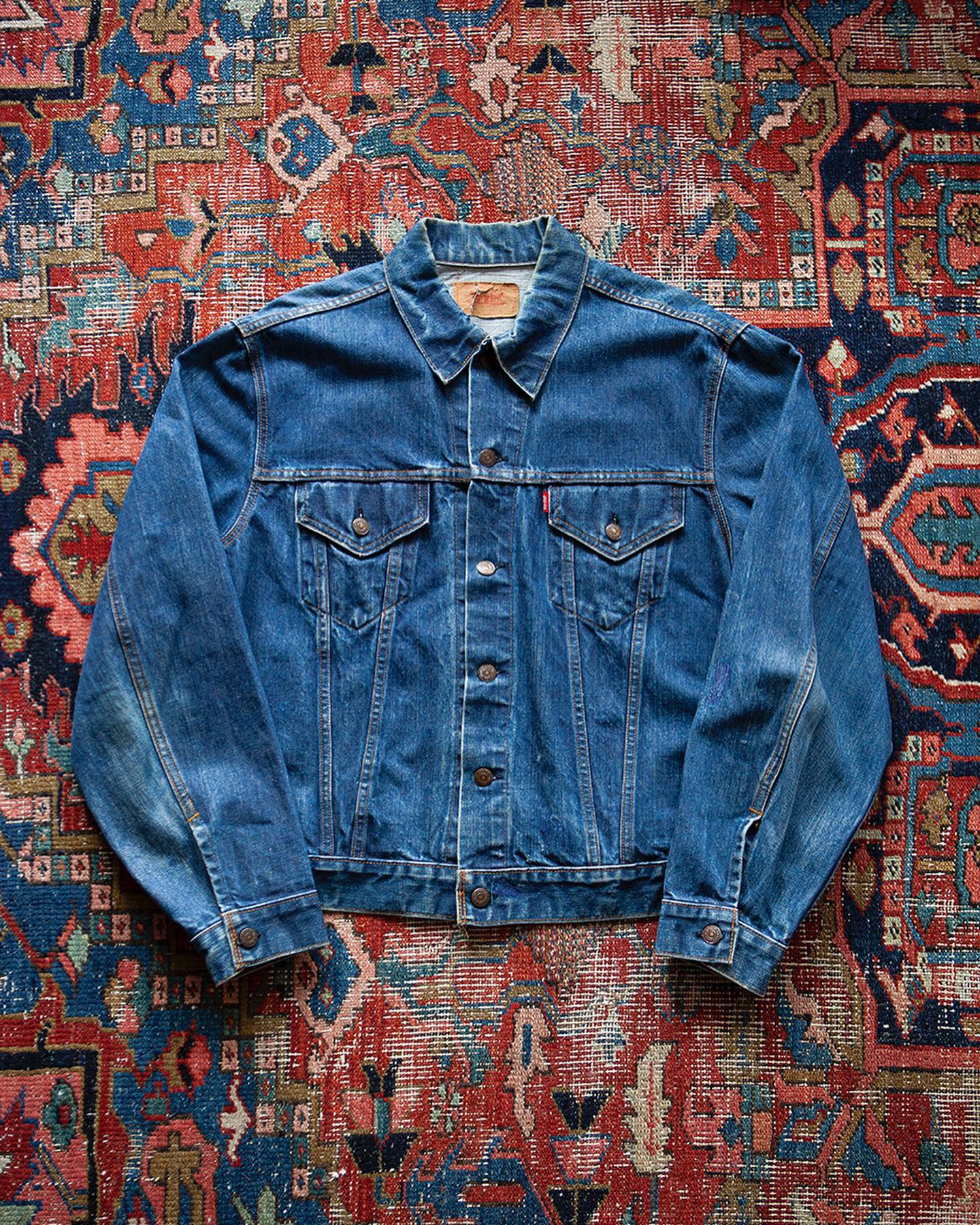 The best vintage shops in Amsterdam | a denim jacket on a paisley pattern rug at Ckx studio