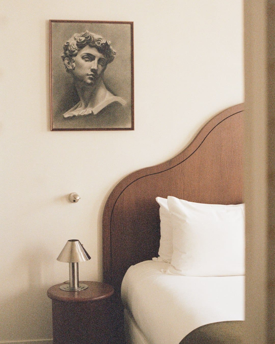 A bedroom with a sketch on the wall at Hôtel des Academies et des Arts, Paris