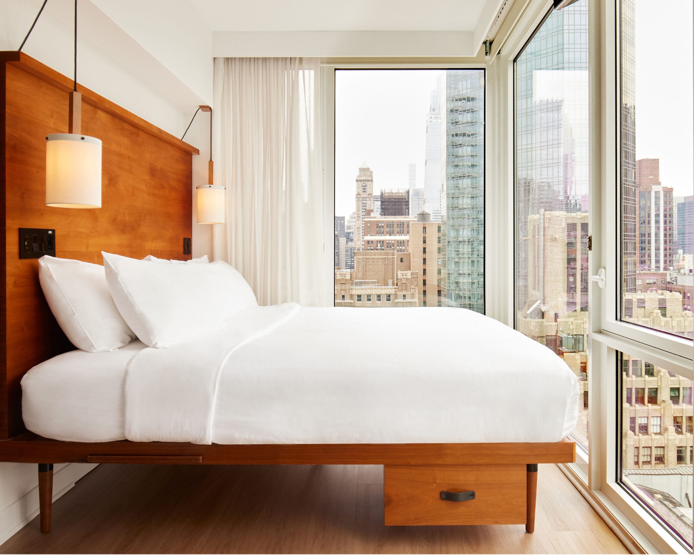 The best hotels in New York | Room at Arlo Nomad with floor to ceiling windows overlooking New York City
