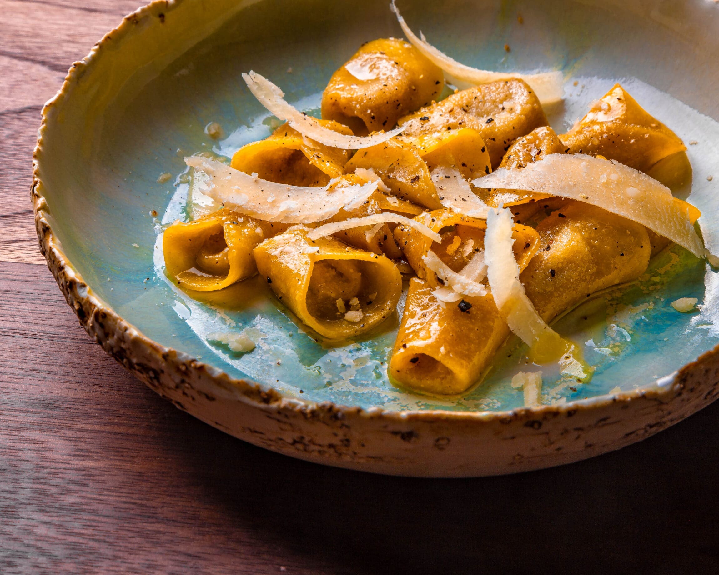 The best restaurants in New York City | Orange coloured pasta dish garnished with parmesan shavings at Foul Witch