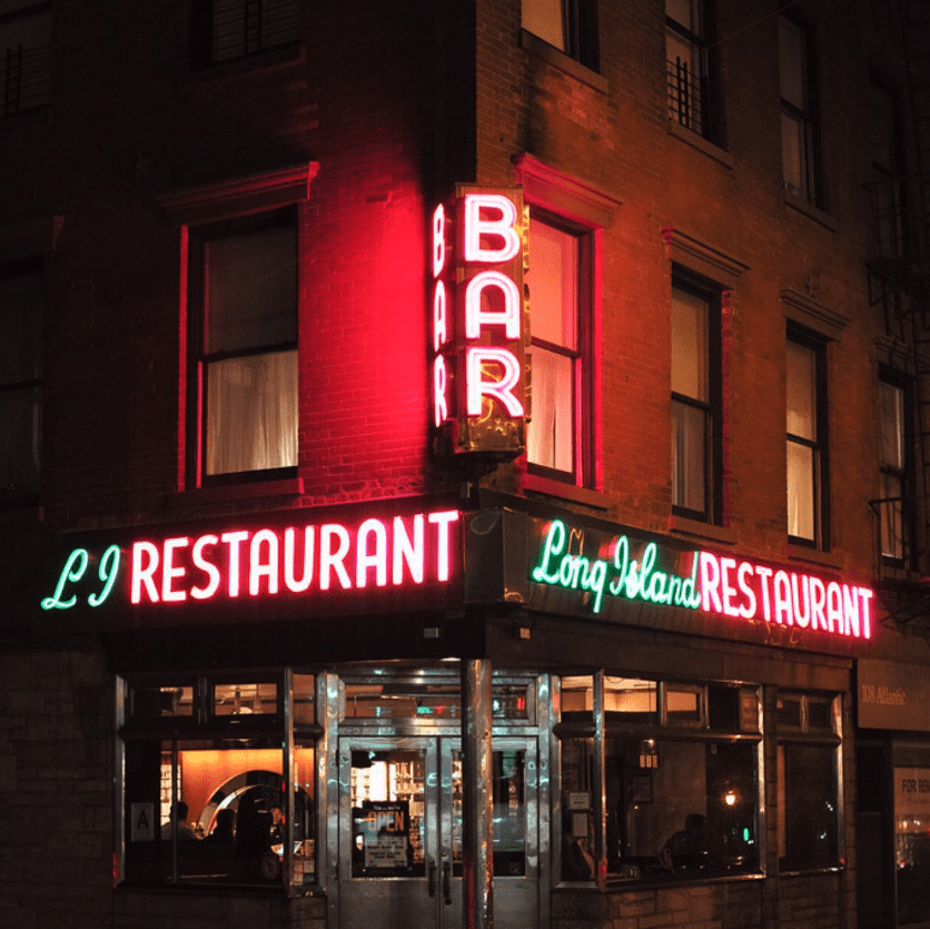 The best cocktail bars in New York | Neon sign at Long Island Bar lighting up New York City at night