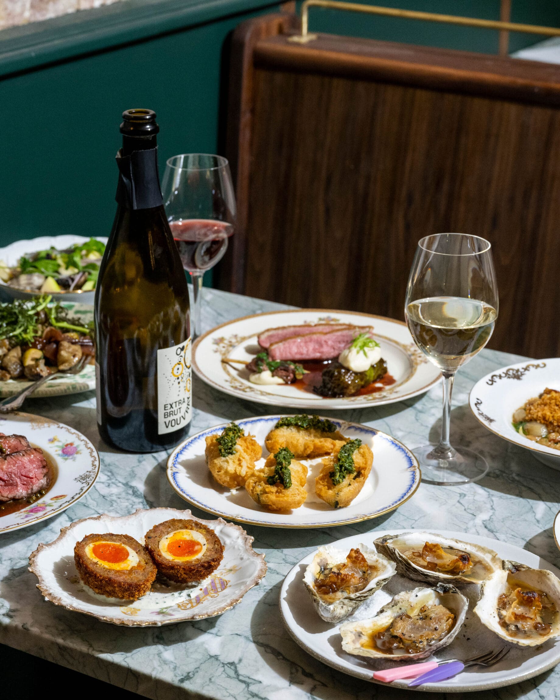 The best restaurants in New York City | Oysters, scotch eggs, steak and salads on a table at Lord's