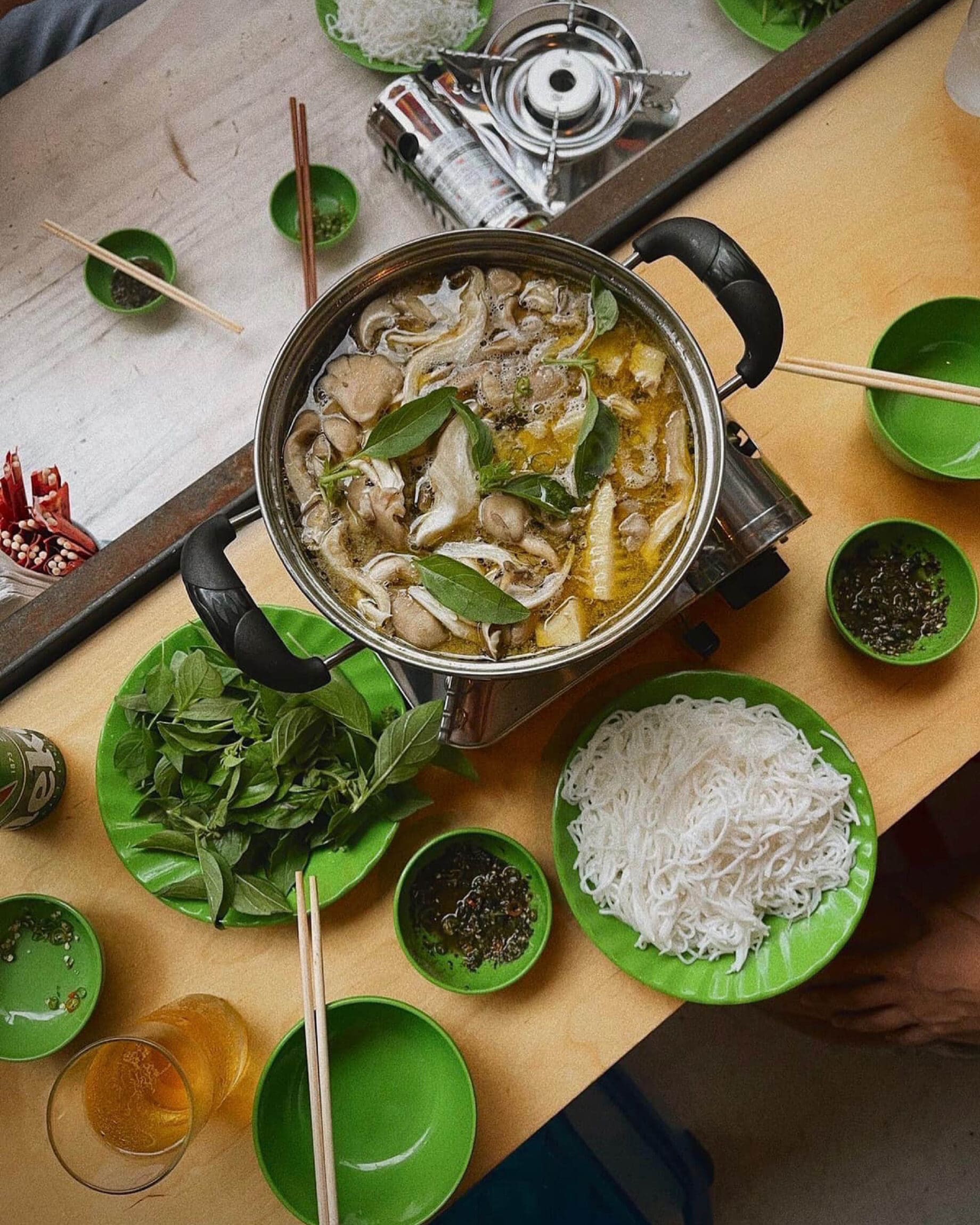 The best restaurants in New York City | Chicken hotpot with citrus basil at Mam served with a side of noodles and sauces.