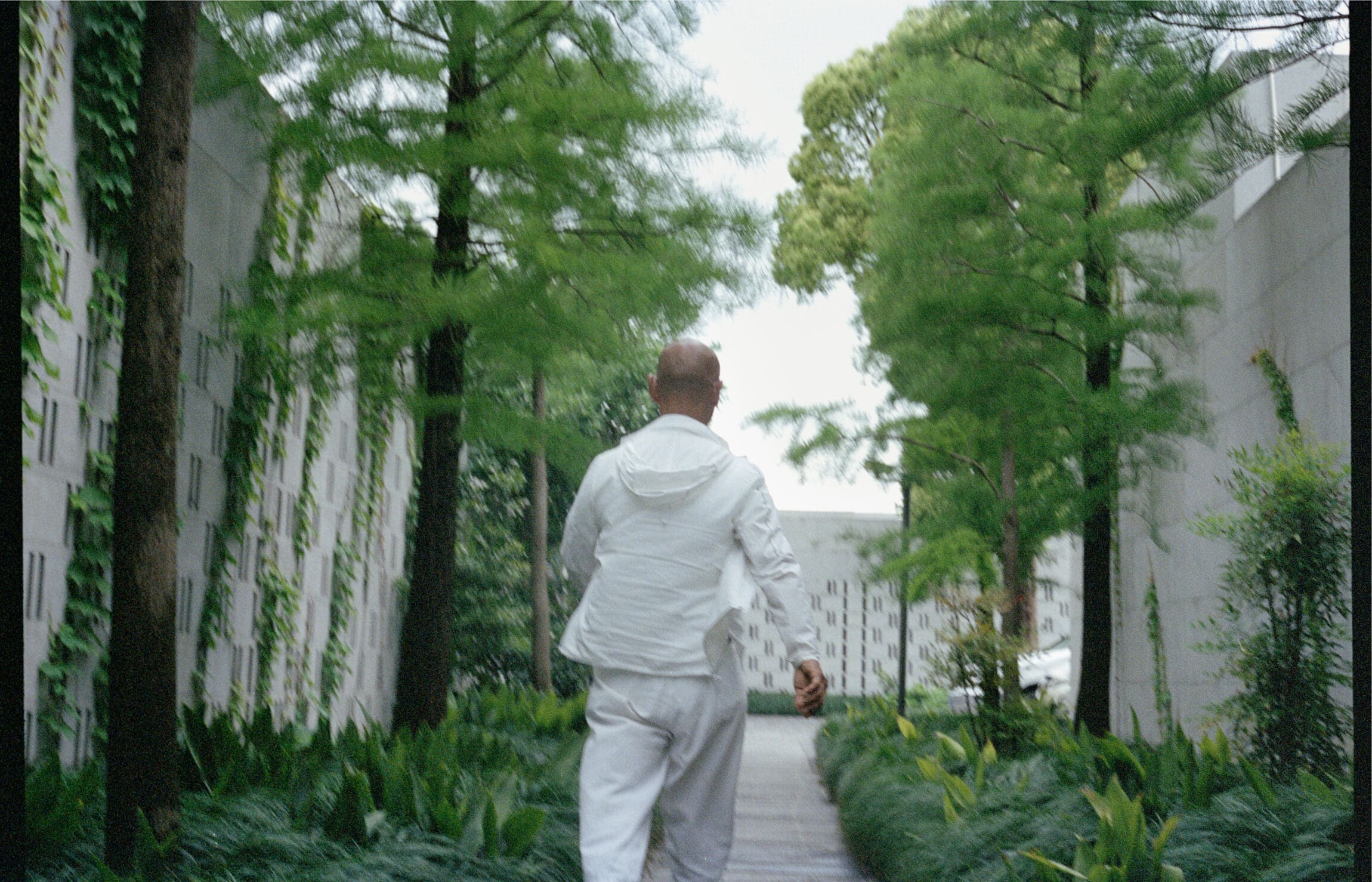 Chinese artist Zhang Huan running through the trees