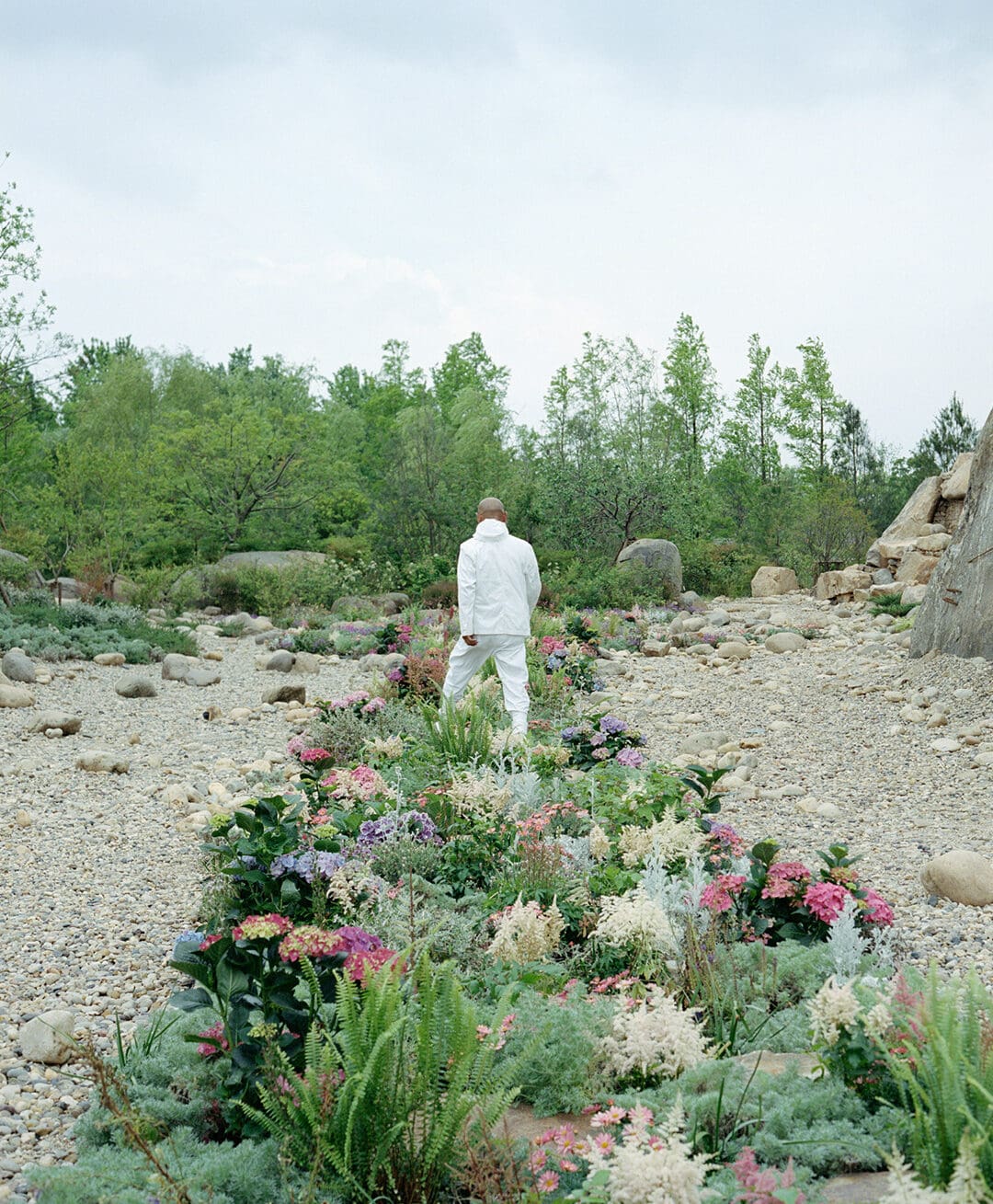 Chinese artist Zhang Huan standing in his Shanghai garden