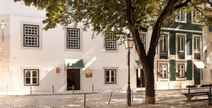 The tree-shaded facade of Hotel das Amoreiras in Lisbon