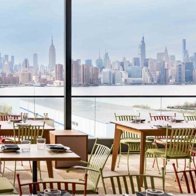New York Skyline from Laser Wolf, showing a warm atmosphere. Very clean lines and tables and chairs.