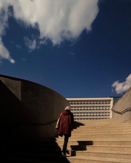 A person walks up the steps to visit the MACAM Museu de Arte Contemporânea Armando Martins in Lisbon on a sunny day