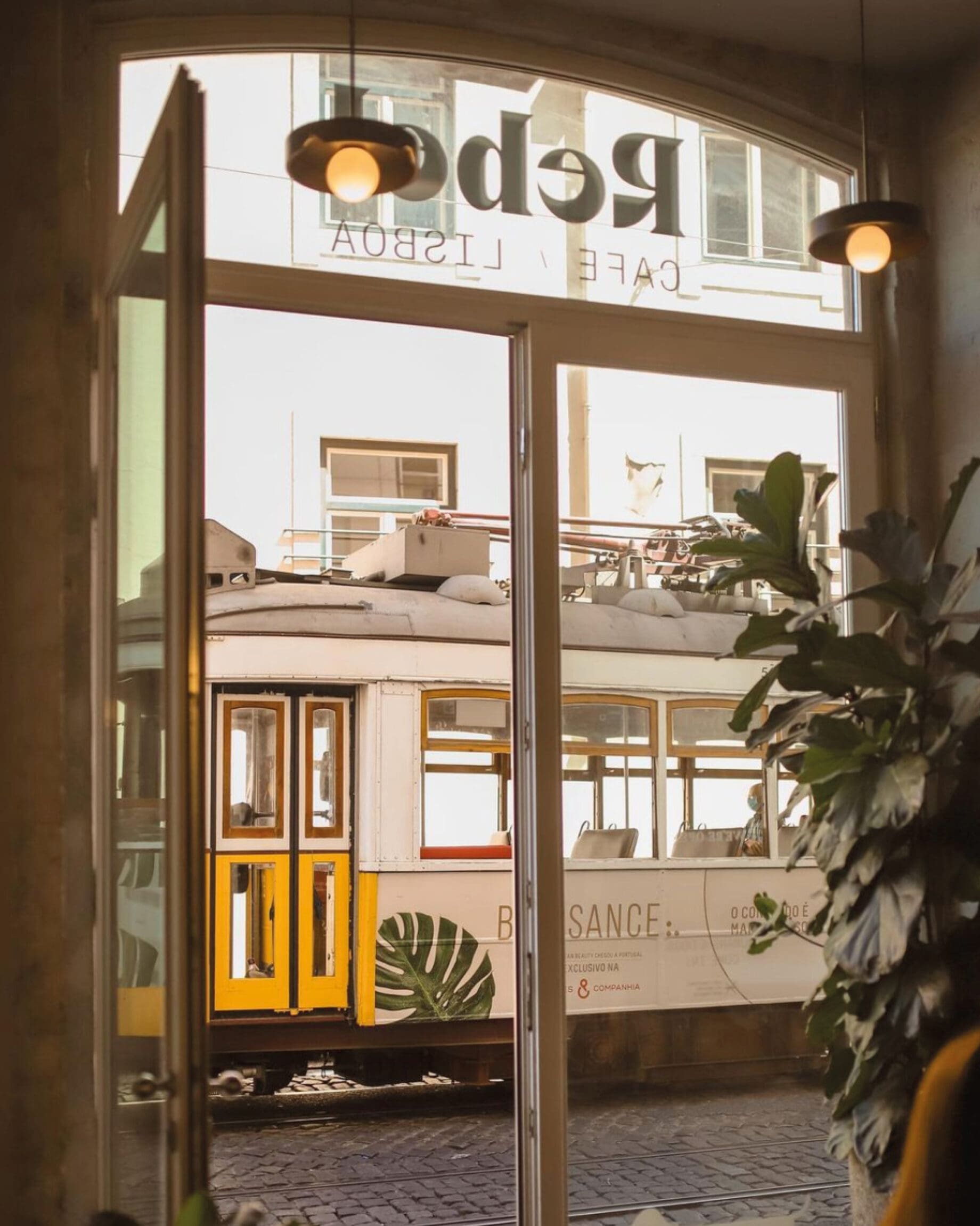 The best cafes for remote working in Lisbon | The glass door of Rebel Cafe, with views of the street