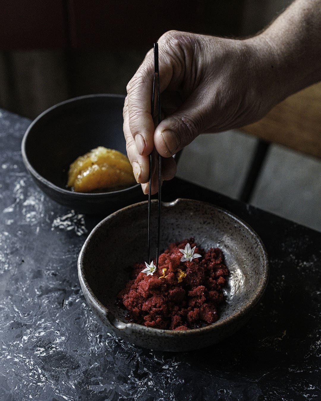 A hand preparing a dish at SEM, Lisbon